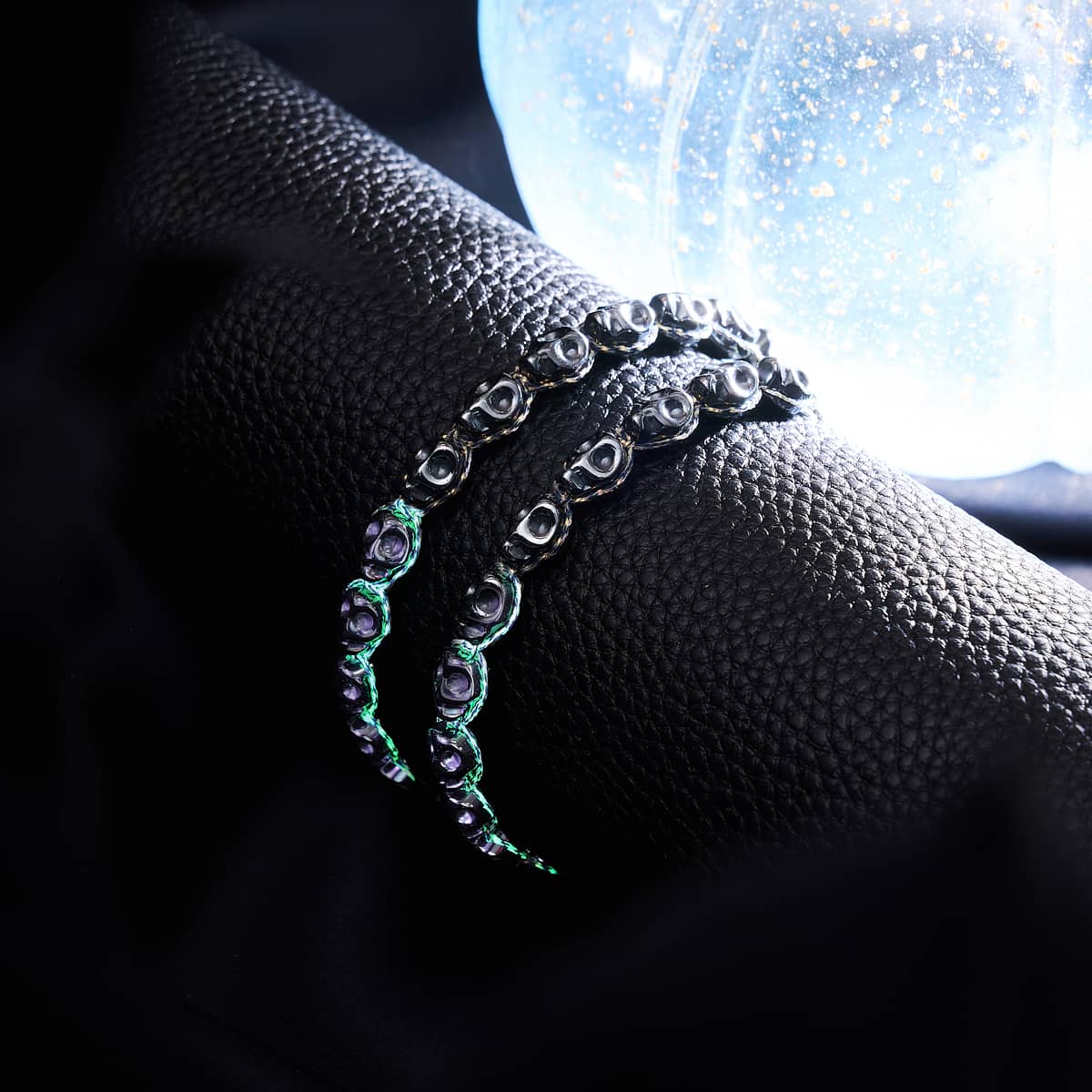 Hades bracelet glowing with adjustable Black GlowWeave cord and Hematite skull beads on stainless steel base by NOGU